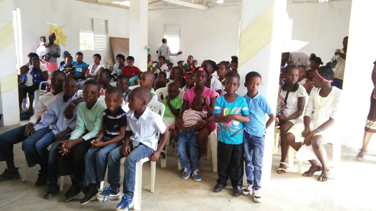 A large group of children and families gathered for a community program