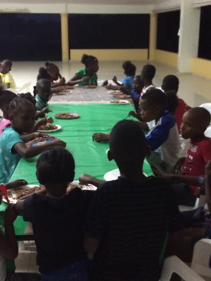 Children sharing a community meal